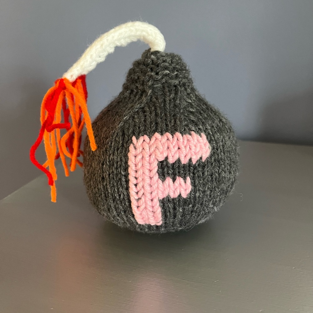 Hand knit F-bomb. 5” X 5” plus fuse length.